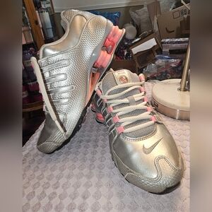 Nike Silver and Pink Sneakers with Rounded Toe and Streamlined Design